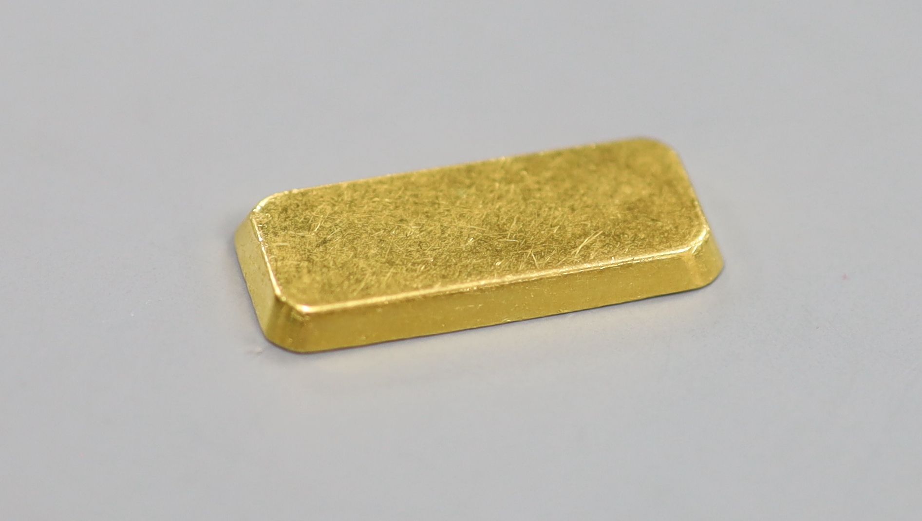 A Degussa 999.9 yellow metal 10 gram ingot.